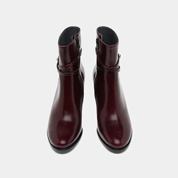 Boots with high heels and gold charms in burgundy leather